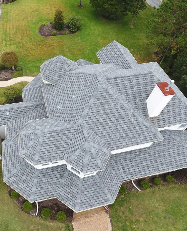 Ariel view of gray shingle roof on large home.