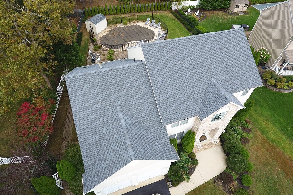 Aerial view showcasing a finished roof repair with gray shingles in Monmouth County NJ, illustrating meticulous workmanship and restoration excellence.